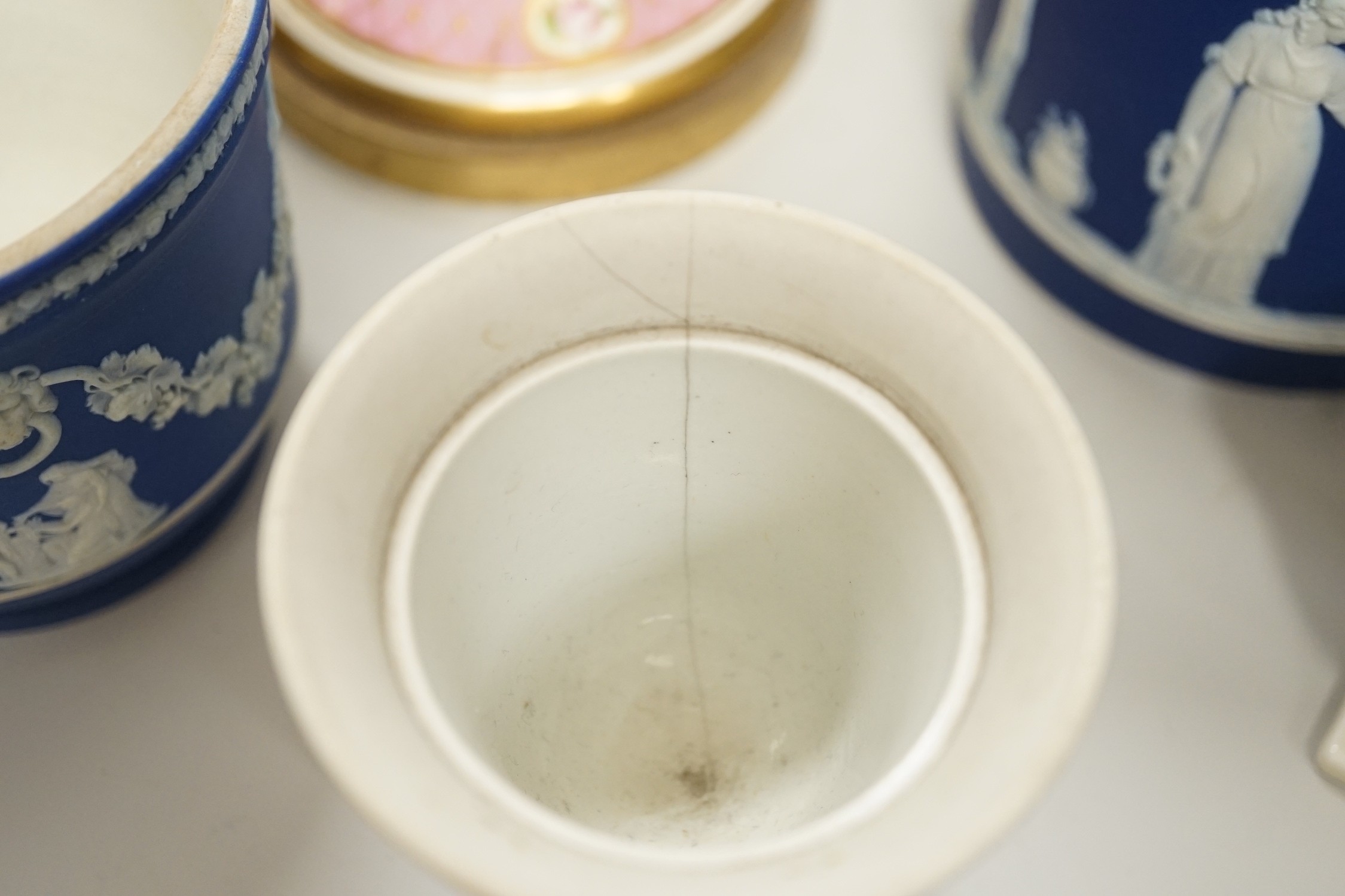 Three mid to late 19th century pieces of Wedgwood Jasperware, including a coffee pot and a small cache-pot, a pair of 19th century porcelain candlesticks converted into lamps